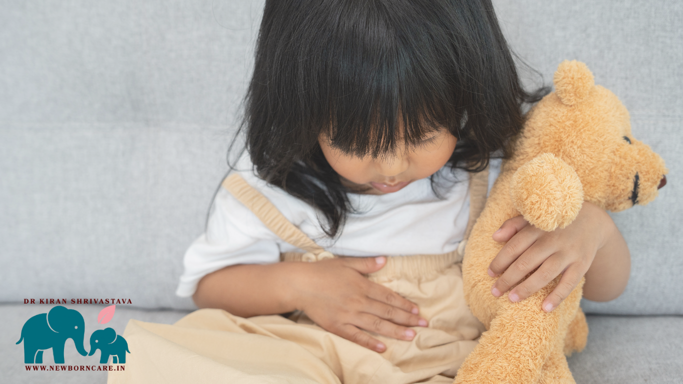 Child with stomach ache holding a teddy bear